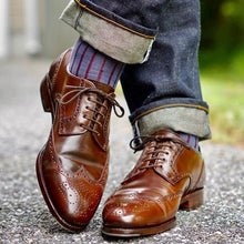 Load image into Gallery viewer, Walnut Water Resistant Leather Cream used to shine and care for these Carmina Armagnac Shell Cordovan Wingtip Derbies worn by Shellvedge and his raw denim with crossed legs