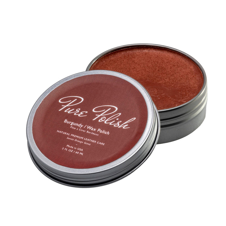 Burgundy Shoe Polish Paste / Wax used for polishing dark red shoes and boots in an open tin on a white background