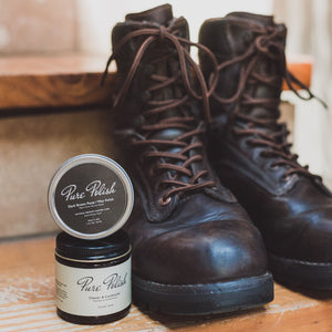 Dark Brown Shoe Polish Paste / Wax used for shining leather shoes and boots on top of Leather Cleaner and Conditioner next to a pair of Danner Boots