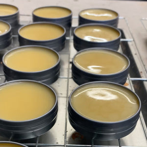 Fresh batch of High Shine Shoe Polish Wax tins cooling on a rack