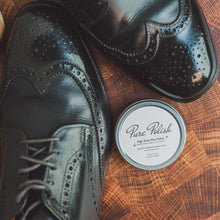 Load image into Gallery viewer, Tin of Pure Polish High Shine Shoe Polish Wax next to a pair of shined black leather brogues