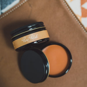 Light Brown Leather Cream Polish open jar on a leather folio